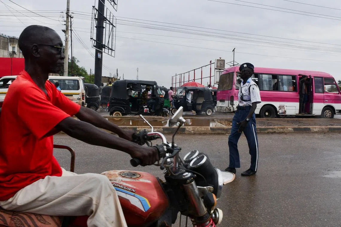FILE PHOTO: A man drives a motorcycle along a street in Juba, South Sudan November 22, 2024. REUTERS/Samir Bol/File Photo