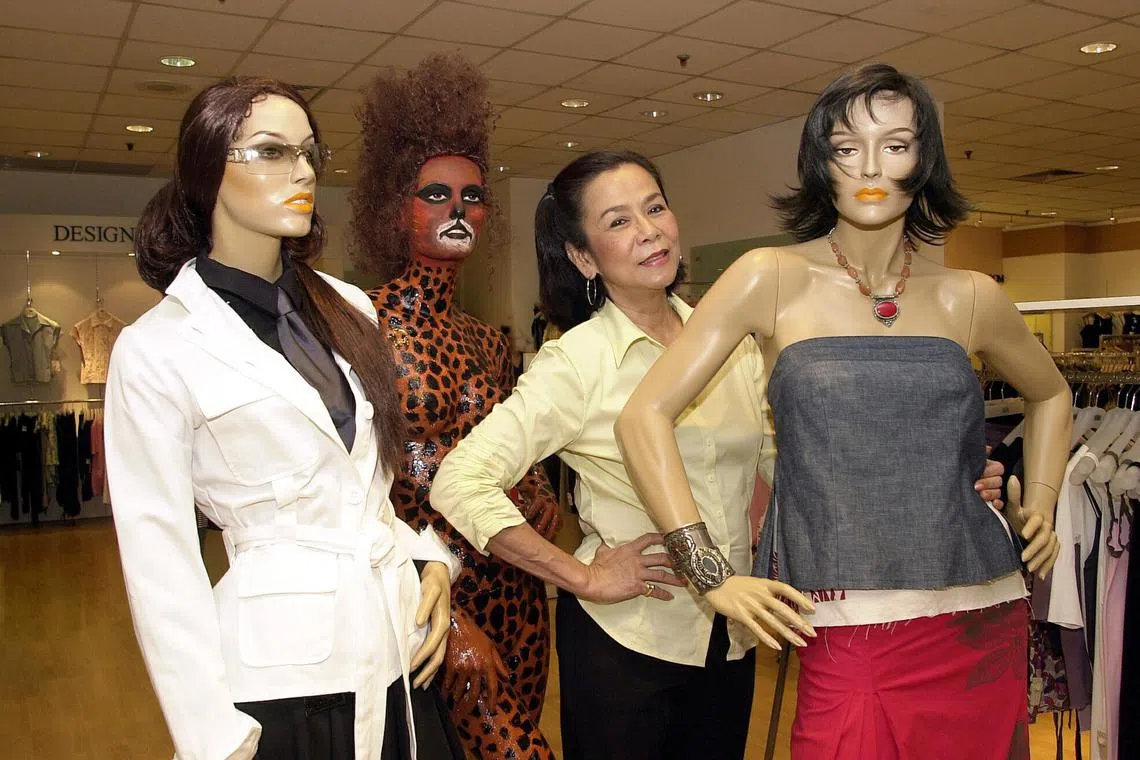 [Former model Mimi Tan, managing director of MiMi Tan's Mannequins Pte Ltd with some of her mannequins. ]