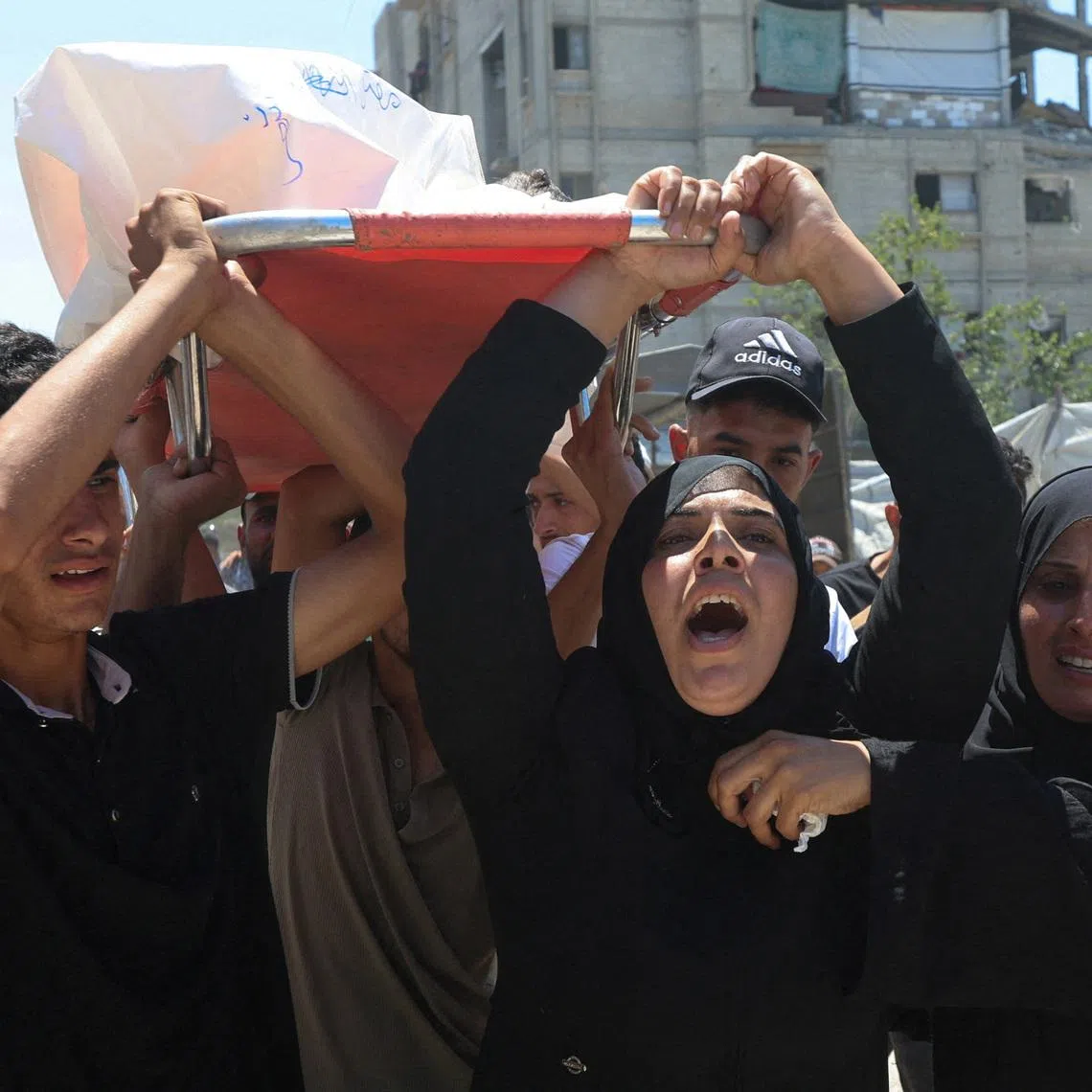 Mother of Palestinian child Muataz Abu Shaar, who was killed by Israeli fire, according to medics, and other mourners carry his body during his funeral  in Khan Younis, in the southern Gaza Strip, July 14, 2026. REUTERS/Ramadan Abed