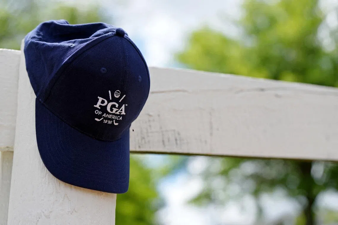 FILE PHOTO: May 18, 2024; Louisville, Kentucky, USA; A detail view of a PGA of America hat resting on a fence post during the third round of the PGA Championship golf tournament at Valhalla Golf Club. Mandatory Credit: Clare Grant-USA TODAY Sports/File Photo