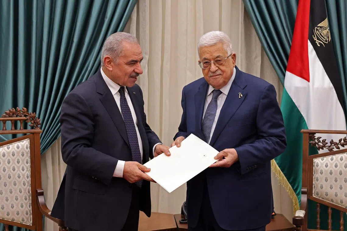This handout picture provided by the Palestinian Authority's Press Office (PPO) shows Palestinian Prime Minister Mohammad Shtayyeh (L) presenting the resignation of his government to President Mahmud Abbas, in Ramallah on February 26, 2024. Shtayyeh announced on February 26 the resignation of his government, which rules parts of the Israeli occupied West Bank, citing the need for change after the Israel-Hamas war in Gaza ends. (Photo by Thaer GHANEM / PPO / AFP) / === RESTRICTED TO EDITORIAL USE - MANDATORY CREDIT "AFP PHOTO / HO / PPO " - NO MARKETING NO ADVERTISING CAMPAIGNS - DISTRIBUTED AS A SERVICE TO CLIENTS ===