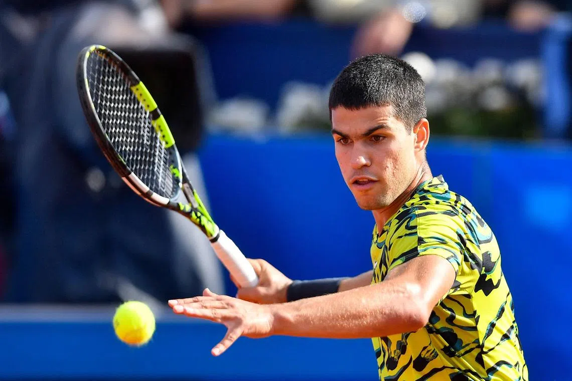 Spain's Carlos Alcaraz returns the ball to Britain's Dan Evans.