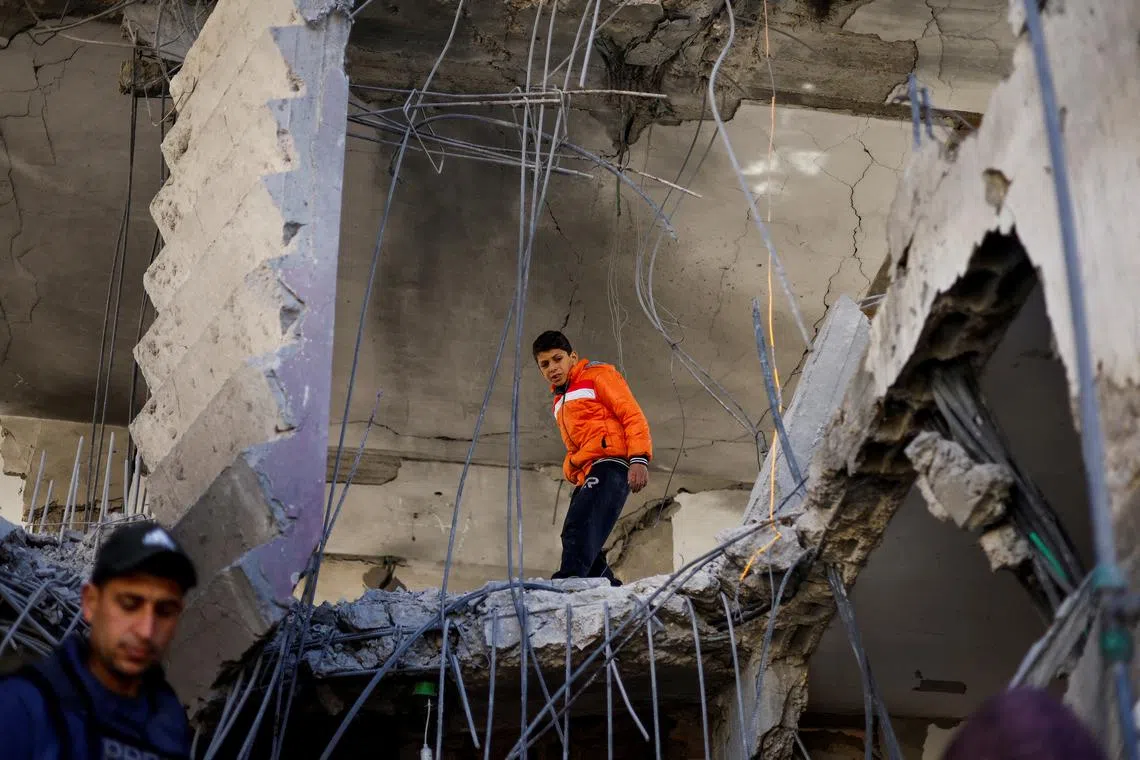 A Palestinian boy reacts at the site of an Israeli strike on a house, amid the ongoing conflict between Israel and the Palestinian Islamist group Hamas, in Rafah, in the southern Gaza Strip, March 25, 2024. REUTERS/Mohammed Salem
