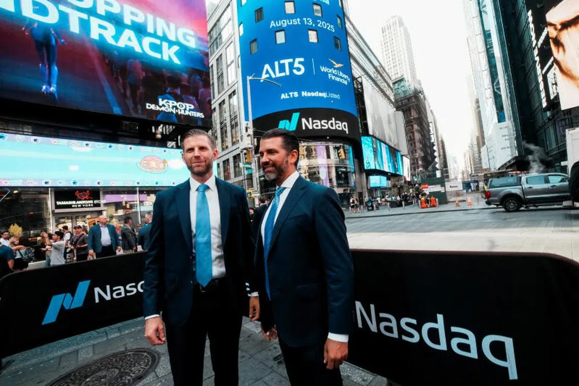 FILE PHOTO: Donald Trump Jr. and Eric Trump pose for pictures outside the Nasdaq building after ringing the opening bell to celebrate the closing of ALT5’s $1.5 billion offering and adoption of its $WLFI Treasury Strategy at the Nasdaq Market, in New York City, U.S., August 13, 2025. REUTERS/Eduardo Munoz/File Photo