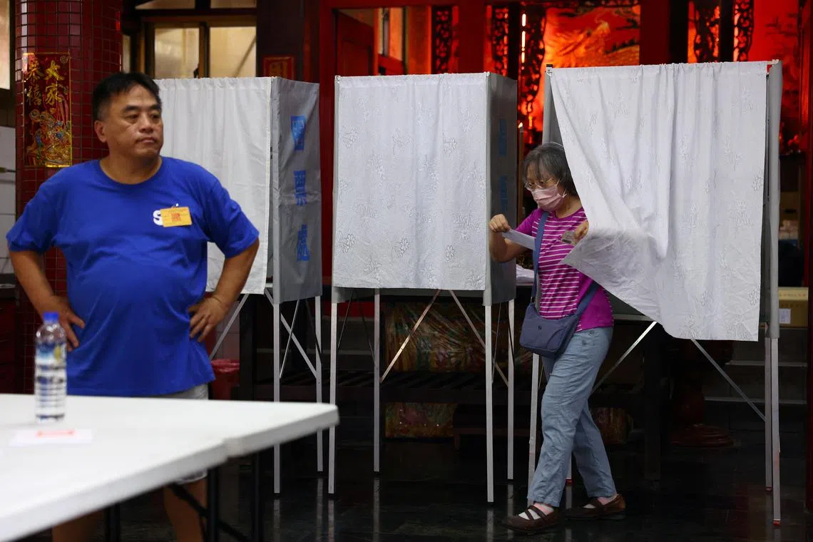 A voter leaves a booth during a recall election, at a polling station in Taipei, Taiwan July 26, 2025. REUTERS/Annabelle Chih