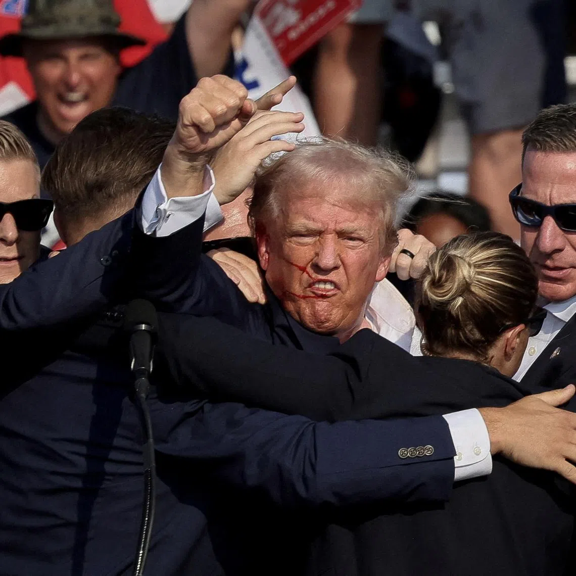 FILE PHOTO: Republican presidential candidate and former U.S. President Donald Trump is assisted by the Secret Service after gunfire rang out during a campaign rally at the Butler Farm Show in Butler, Pennsylvania, U.S., July 13, 2024. REUTERS/Brendan McDermid/File Photo