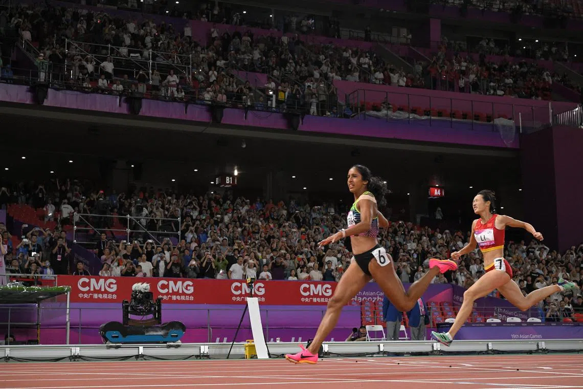 Shanti Pereira of Singapore crosses the line to win the 19th Asian Games Athletics Women’s 200m final at the Hangzhou Olympic Sports Centre Stadium on Oct 2, 2023.