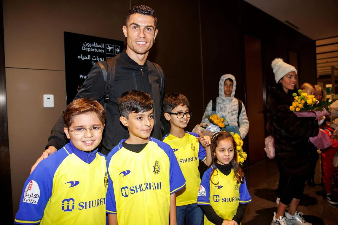 Cristiano Ronaldo posing for picture with Saudi kids upon his arrival at a private airport in Riyadh, on the eve of his grand unveiling before thousands of fans at Saudi Arabia's Al Nassr club, after sealing a shock move estimated at more than €200 million (S$286 million).