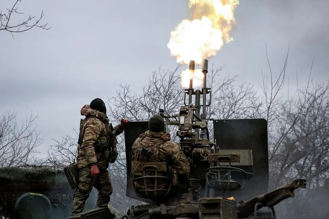 FILE PHOTO: Ukrainian servicemen fire an anti-aircraft cannon near Bakhmut, March 6, 2024. Radio Free Europe/Radio Liberty/Serhii Nuzhnenko via REUTERS