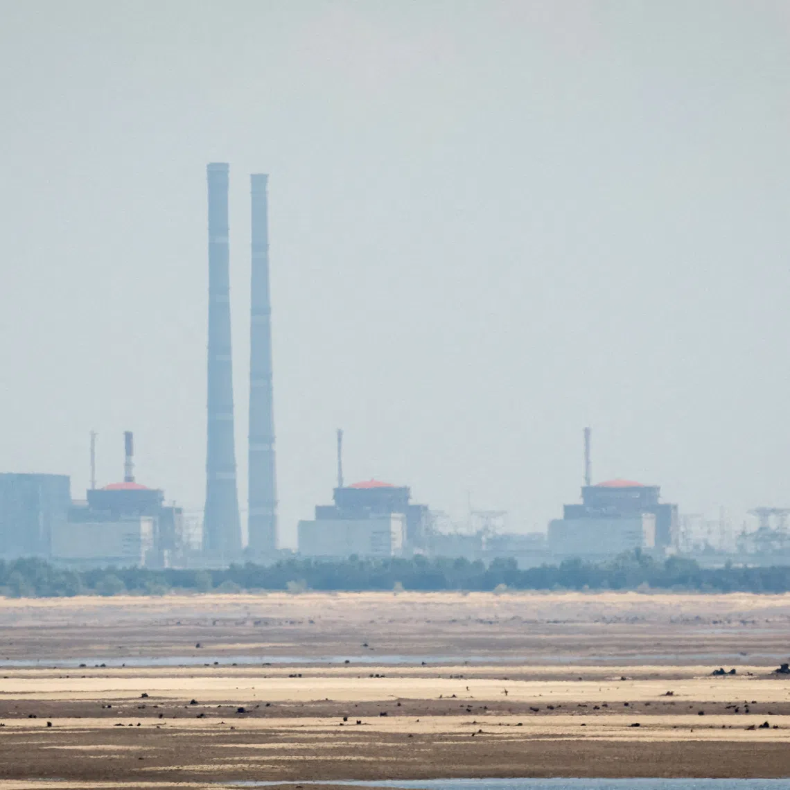 FILE PHOTO: A view shows Zaporizhzhia Nuclear Power Plant from the bank of Kakhovka Reservoir near the town of Nikopol after the Nova Kakhovka dam breached, amid Russia's attack on Ukraine, in Dnipropetrovsk region, Ukraine June 16, 2023. REUTERS/Alina Smutko/File Photo