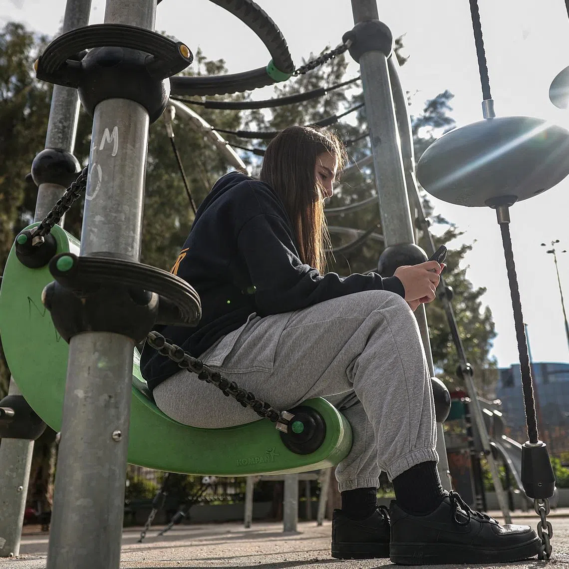 Katerina Daniil, 14, looks at social media posts, as Greece is set to ban under-15s from social media in European crackdown, in Athens, Greece, February 26, 2026. REUTERS/Louisa Gouliamaki