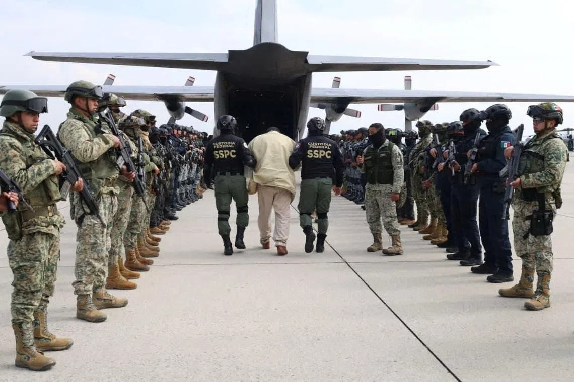 Agents of Mexico’s Secretariat of Security and Citizen Protection escort a detainee as Mexico sends another 37 alleged members of criminal organizations to the United States, at Adolfo Lopez Mateos International Airport in San Pedro Totoltepec, Mexico, in this handout photo distributed on January 20, 2026. Ministry of Security and Citizen Protection/Handout via REUTERS