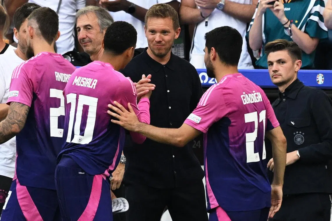 FILE PHOTO: Soccer Football - Euro 2024 - Group A - Germany v Hungary - Stuttgart Arena, Stuttgart, Germany - June 19, 2024 Germany coach Julian Nagelsmann shakes hands with Jamal Musiala after the match REUTERS/Angelika Warmuth/File Photo