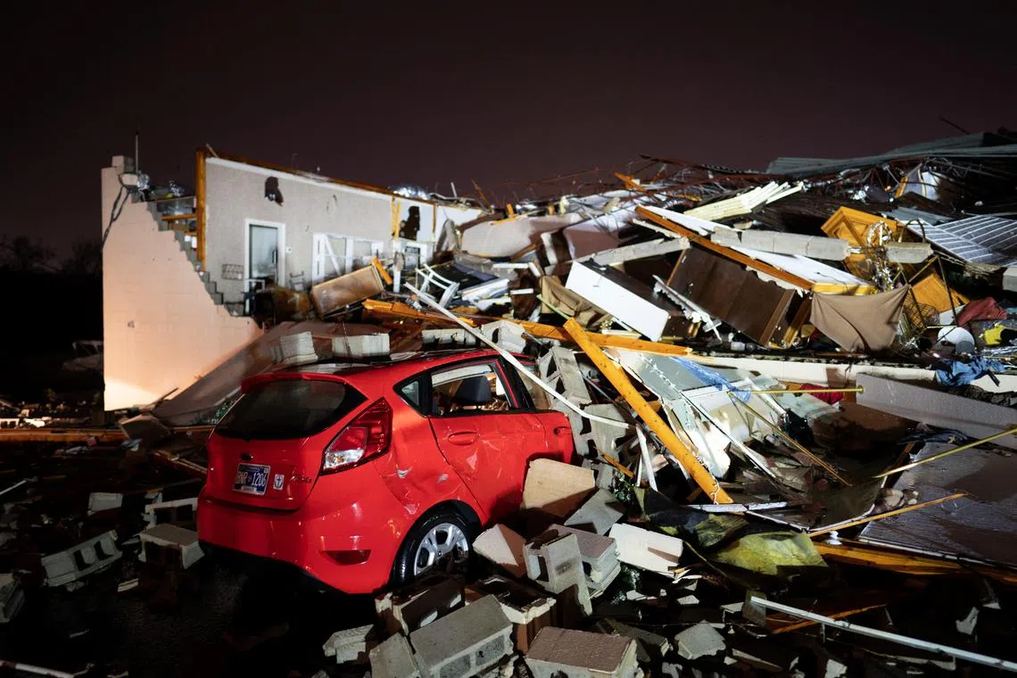 A car is buried under rubble on Main Street after a tornado hit Hendersonville, Tennessee on Dec 9. 