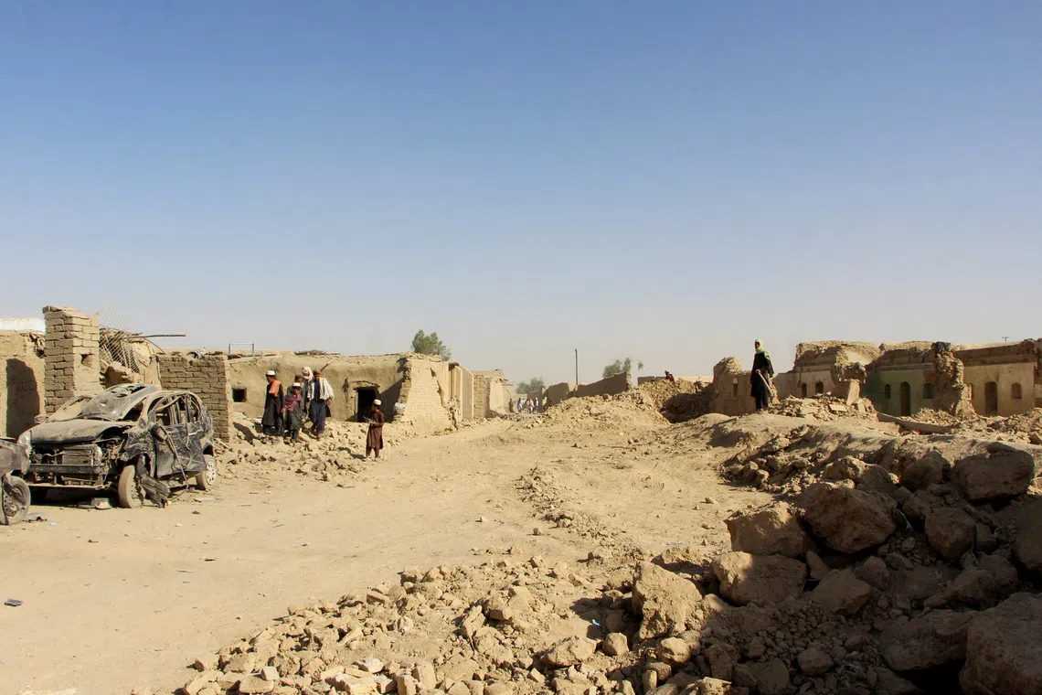 FILE PHOTO: People inspect houses and vehicles destroyed during an airstrike, following a temporary ceasefire, amid the conflict between Afghanistan and Pakistan, in Spin Boldak district of Kandahar Province, Afghanistan, October 16, 2025. REUTERS/Stringer/ File Photo