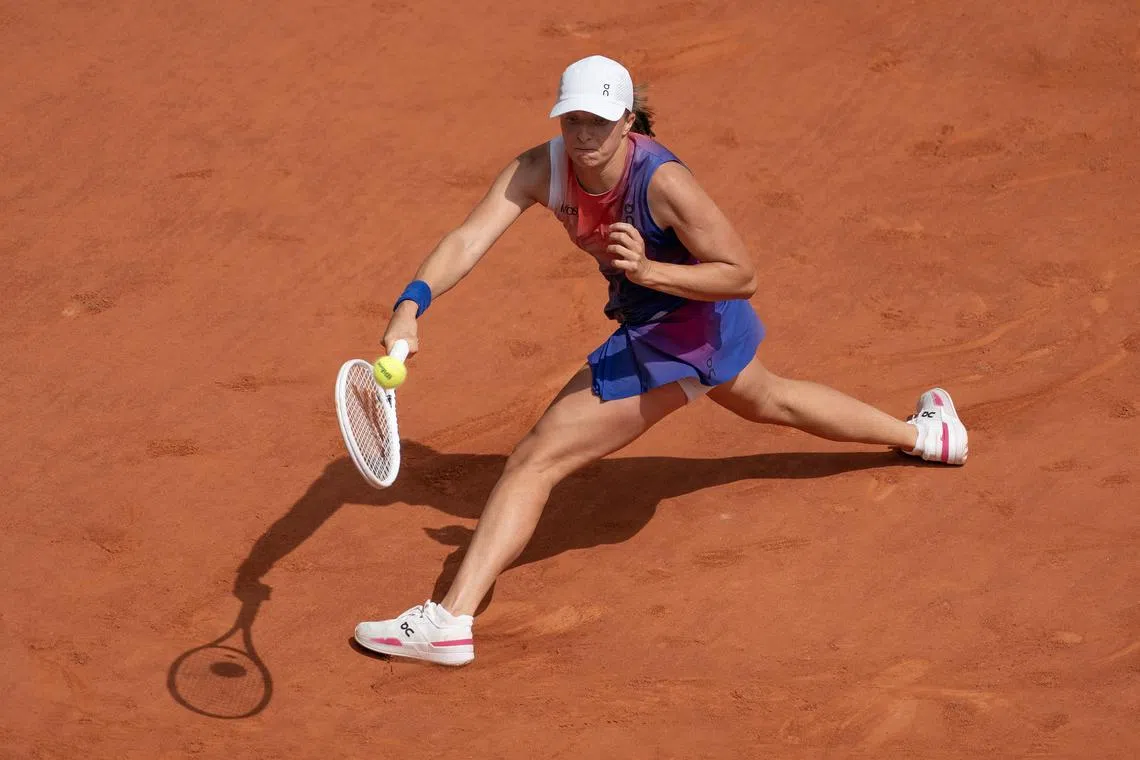 FILE PHOTO: Jun 8, 2024; Paris, France; Iga Swiatek of Poland returns a shot during her match against Jasmine Paolini of Italy on day 14 of Roland Garros at Stade Roland Garros. Mandatory Credit: Susan Mullane-USA TODAY Sports