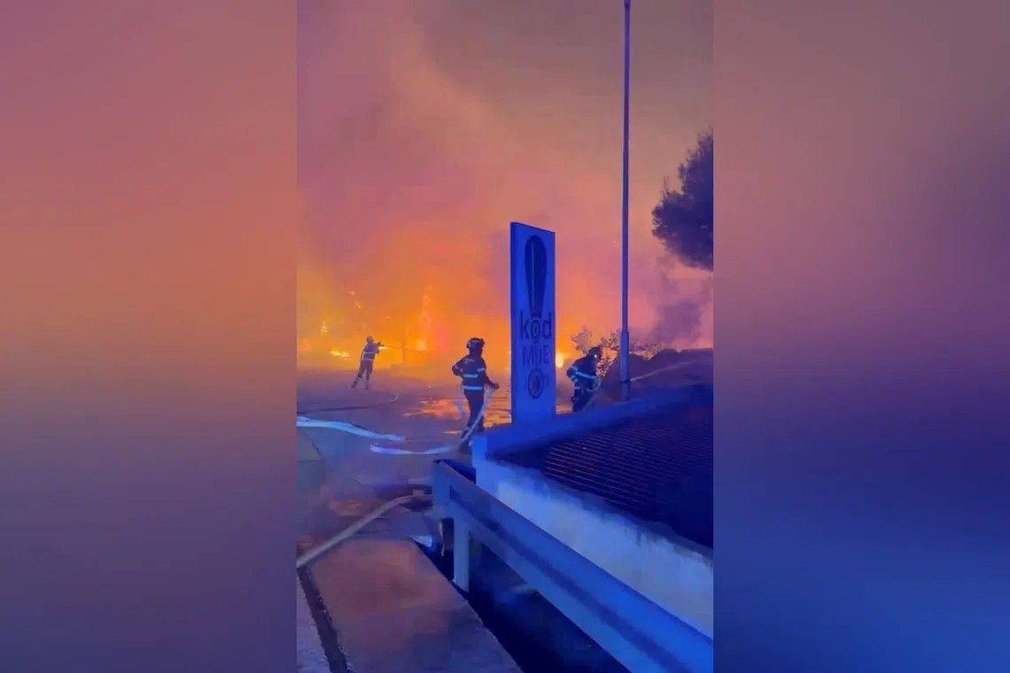 Firefighters work to extinguish a wildfire in Omis, Croatia, on Aug 13.