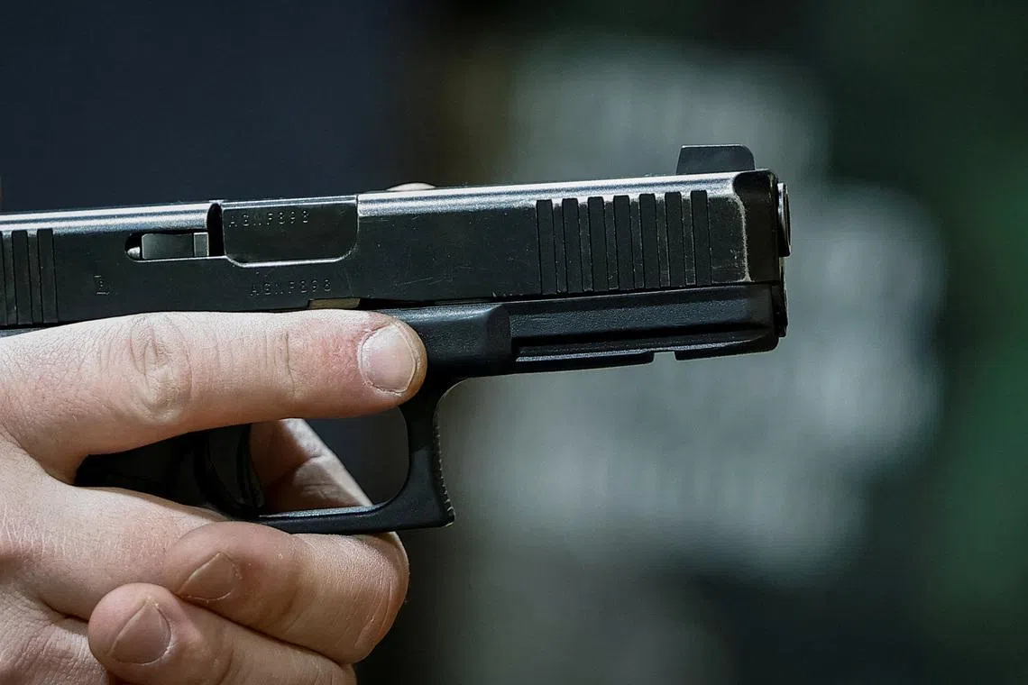 An instructor practices shooting with a handgun at a shooting range, amid Russia's attack on Ukraine, in Kyiv, Ukraine, April 20, 2026. REUTERS/Alina Smutko