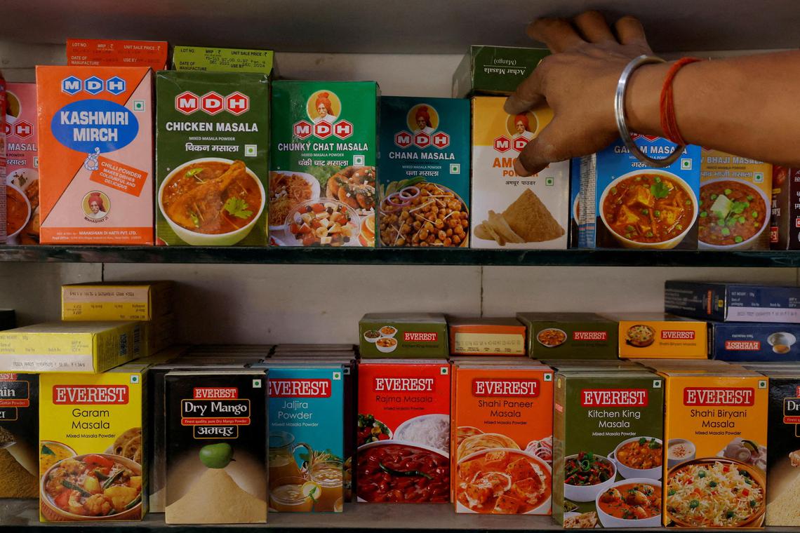 FILE PHOTO: A man adjusts the spice boxes of MDH and Everest on the shelf of a shop at a market in New Delhi, India, April 29, 2024. REUTERS/Adnan Abidi/File Photo