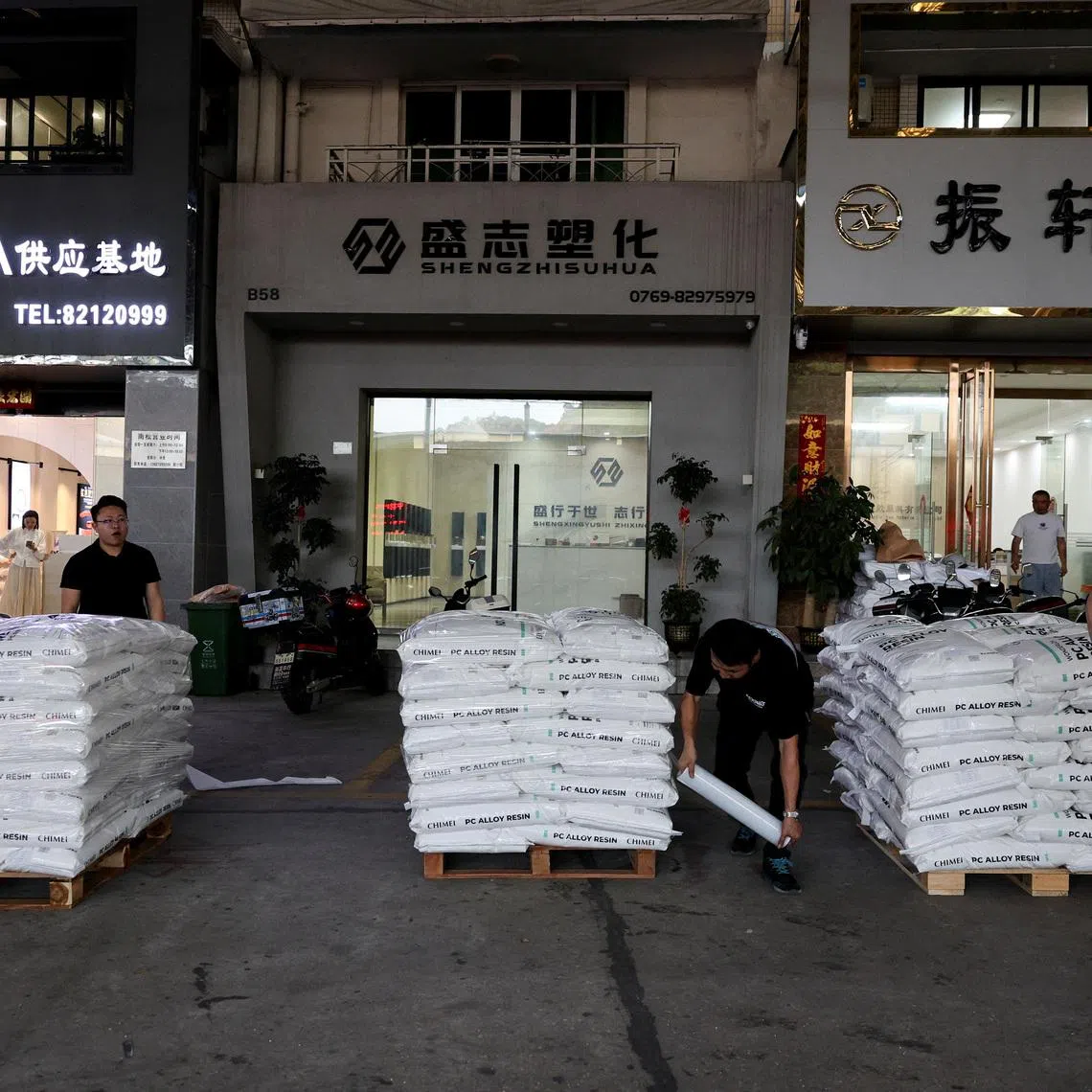 Workers prepare to ship bags of plastic pellets in Zhangmutou Town, also known as “Plastic City”, as rising oil prices drive up production costs for plastic manufacturers, in Dongguan, Guangdong province, China, April 1, 2026.  REUTERS/Go Nakamura