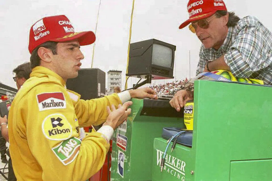 A 1995 photo shows Brazilian racing driver Wilson Fittipaldi (right) with his son Christian, then a rookie driver, at the Indianapolis Motor Speedway in the US.