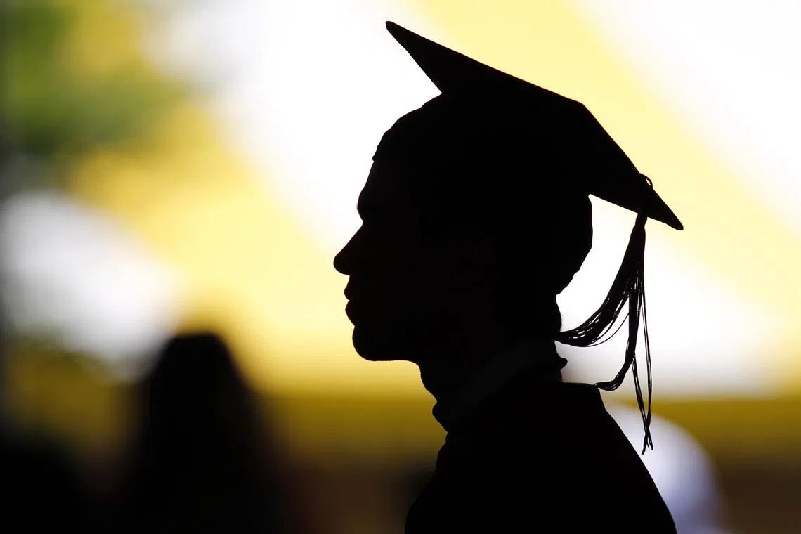 FILE PHOTO: Students attend their graduation ceremony. REUTERS/Brian Snyder/File Photo