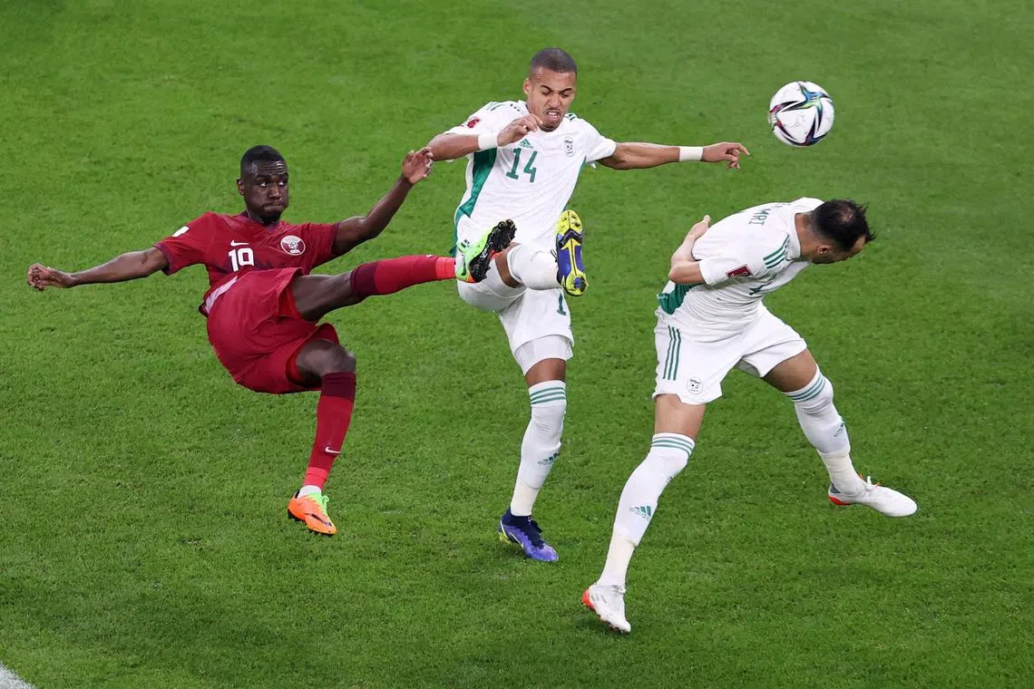 Qatar's Almoez Ali shoots at goal in a match against Algeria.