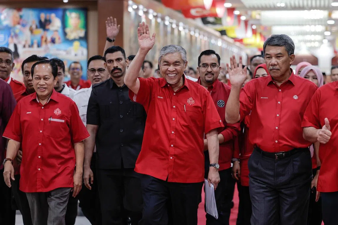 Umno president Zahid (second from right) and his deputy Mohamad Hasan (right) at the party's annual assembly on Wednesday.