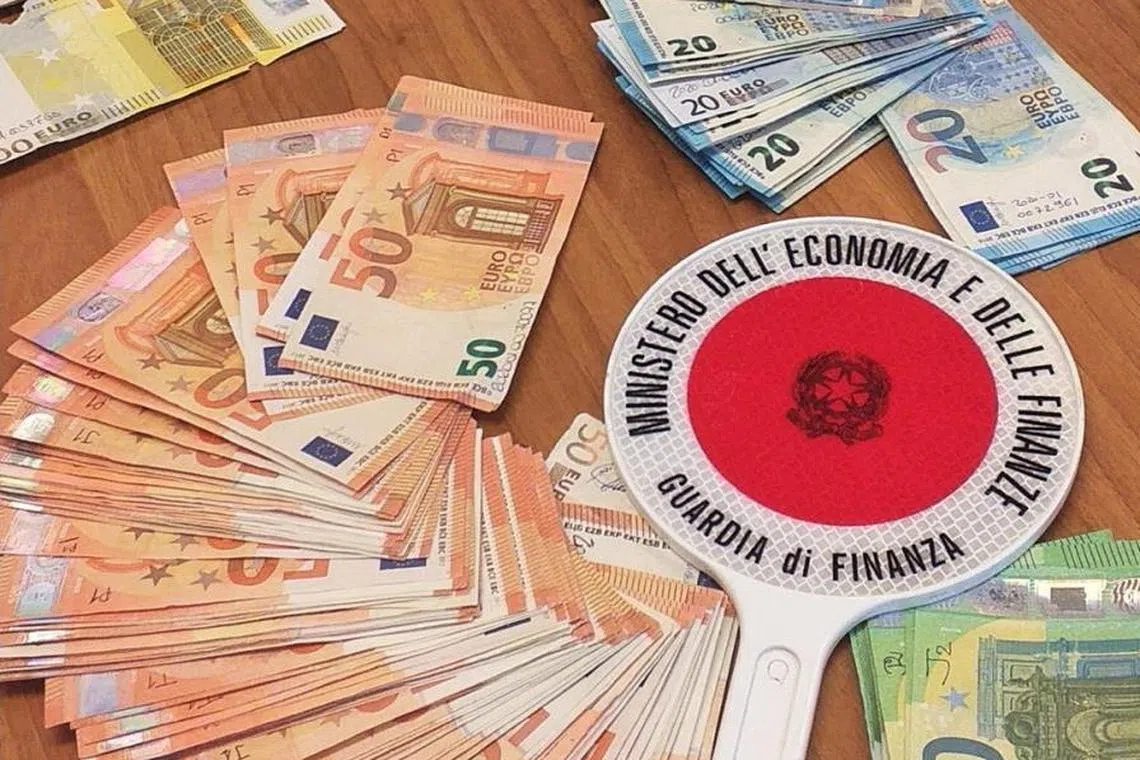 FILE PHOTO: An undated handout picture obtained by Reuters on January 25, 2024 shows banknotes that were seized as a part of an operation against a tax fraud, with the money laundered through a system of so-called Chinese shadow banks in Ancona, Italy. Guardia di Finanza Press Office/Handout via REUTERS /File Photo