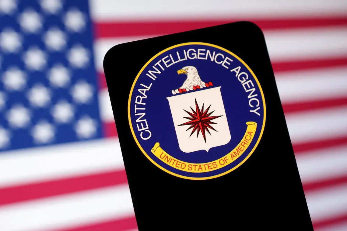 FILE PHOTO: CIA (Central Intelligence Agency) logo and U.S. flag are seen in this illustration taken May 6, 2025. REUTERS/Dado Ruvic/Illustration/File Photo