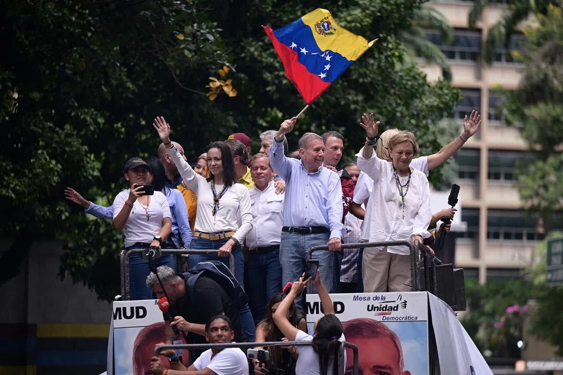 Opposition leader Maria Corina Machado and opposition candidate Edmundo Gonzalez wave as they address supporters after election results awarded Venezuela's President Nicolas Maduro with a third term, in Caracas, Venezuela July 30, 2024. REUTERS/Gaby Oraa/File Photo
