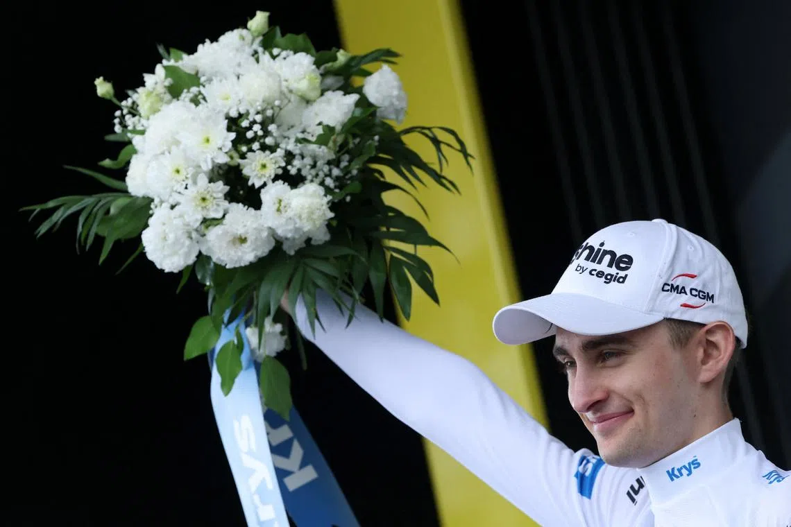 Cycling - Tour de France - Stage 14 - Mulhouse to Le Markstein Fellering - Le Markstein Fellering, France - July 18, 2026 Decathlon CMA CGM Team's Paul Seixas celebrates on the podium wearing the white jersey after stage 14 REUTERS/Gonzalo Fuentes