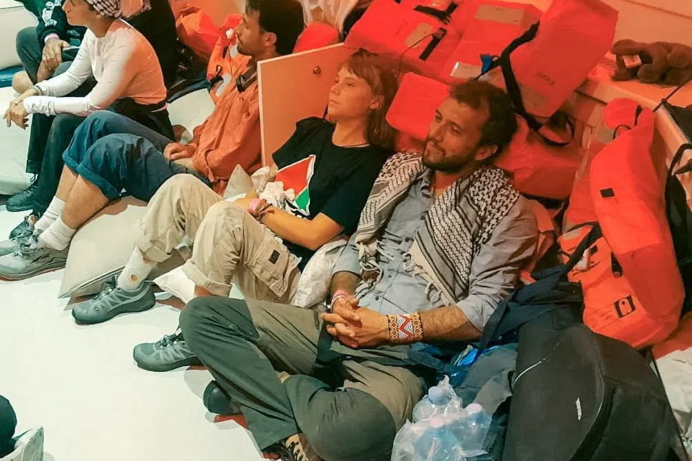 Swedish activist Greta Thunberg (centre) and other activists being taken to Israel on a vessel that was part of the flotilla, which activists said carried food and medicine bound for Gaza.