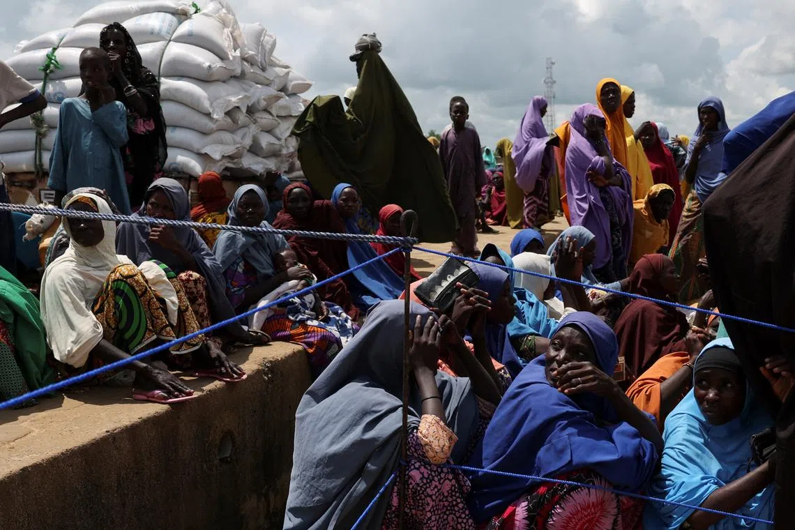Beneficiaries from different Internally Displaced Persons camps wait to receive support following the exit of USAID, at a World Food Programme distribution centre in Dikwa, Borno State, Nigeria, August 27, 2025. REUTERS/Sodiq Adelakun.