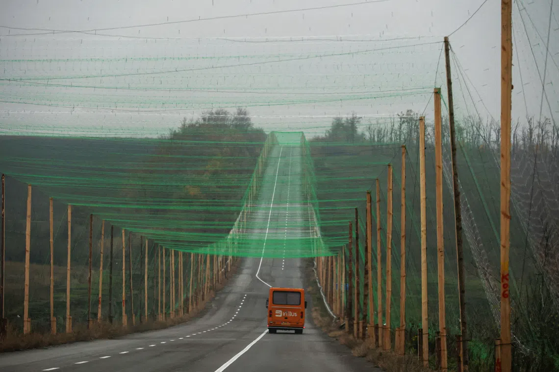 A car drives along a road covered with an anti-drone net amid Russia’s attack on Ukraine, near the town of Sloviansk in the Donetsk region, Ukraine on Oct 27, 2025.   