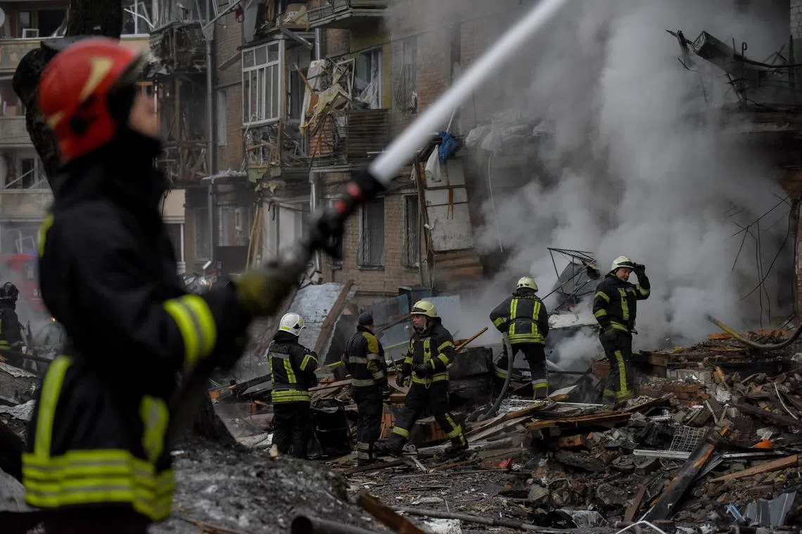 Firefighters work at the site of an apartment block destroyed by Russian shelling in Vyshhorod, near Kyiv, on Nov 23, 2022.