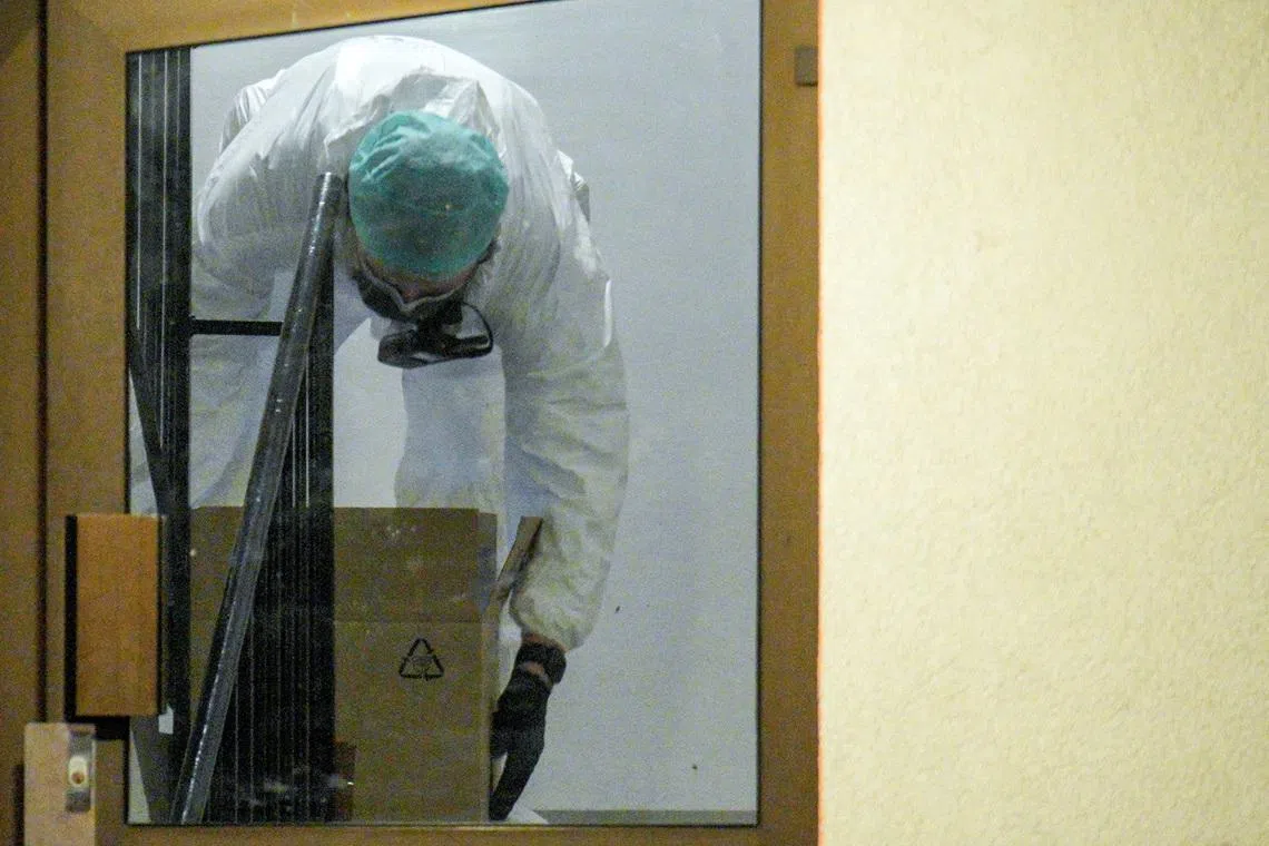 A forensic investigator works at the scene on Wednesday evening in connection with the detention of three brothers after the explosion at the U.S. embassy in Oslo on Sunday night, March 11, 2026. Stian Lysberg Solum /NTB/via REUTERS