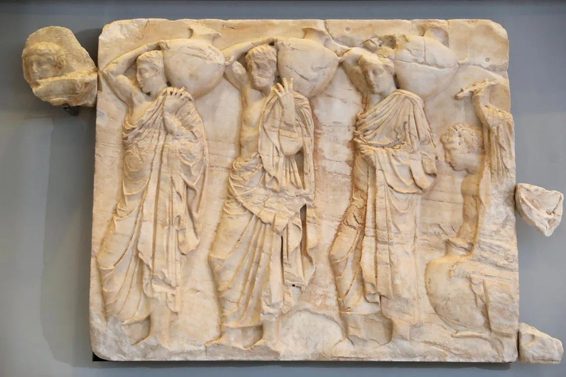 One of the three marble fragments (L) placed in its final position on the gallery of the Acropolis Museum in Athens, Greece, on March 24, 2023. 