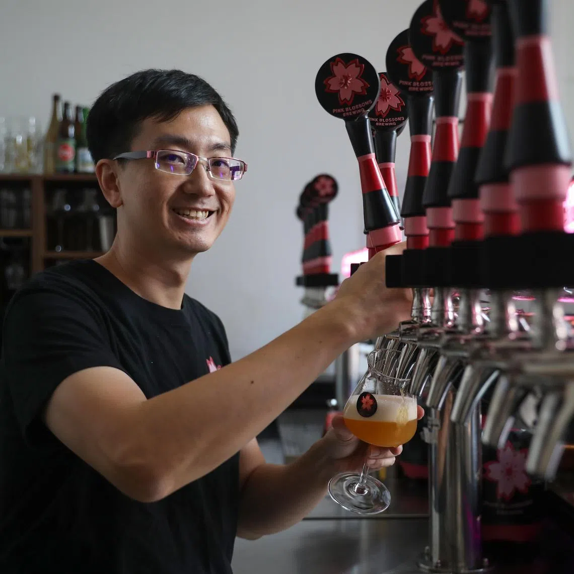 ST20250425_202562600771/elbeer/Taryn Ng// Mr Teo Hong Han, founder and head brewer of Pink Blossoms Brewing, pictured pouring a cup of beer at his brewery on April 25, 2025. He created two general elections themed beers named "Elections Endgame" which is reddish in colour and "A New Hope", which has a golden colour. ST PHOTO: TARYN NG
