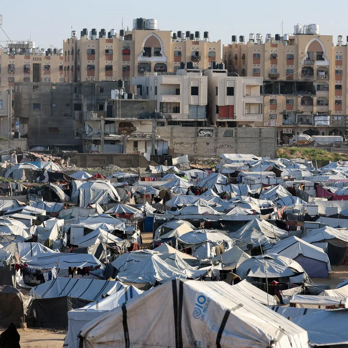 Palestinians displaced during the two-year Israeli offensive shelter at a tent camp in Khan Younis in the southern Gaza Strip, February 10, 2026. REUTERS/Ramadan Abed