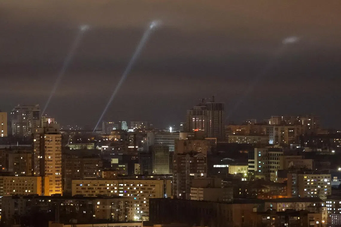 Ukrainian service personnel use searchlights as they search for drones in the sky over Kyiv during a Russian drone strike on Ukraine on March 18. 