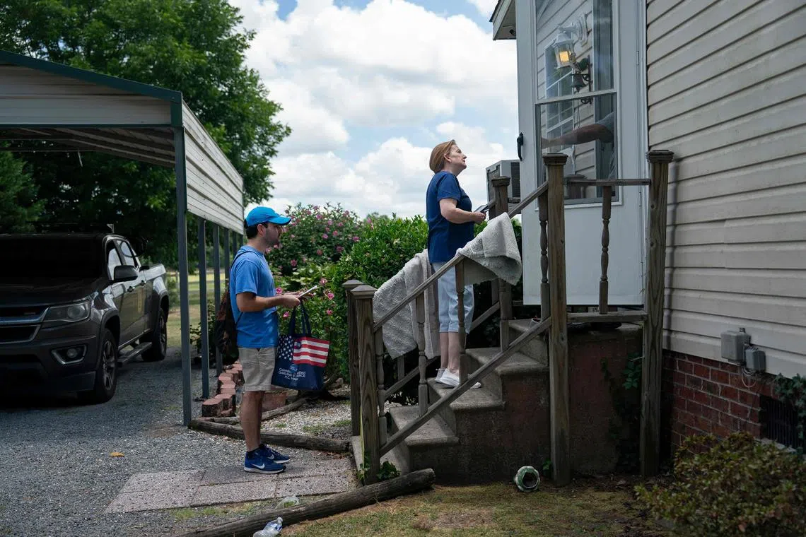 Ms Sarah Hardy and Mr Yampiere Lugo canvass a neighborhood on June 22, 2024, in Laurinburg, North Carolina.