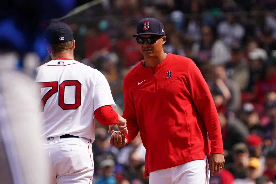 FILE PHOTO: Apr 21, 2022; Boston, Massachusetts, USA; Boston Red Sox acting manager Will Venable (86) relives relief pitcher Ryan Brasier (70) in the sixth inning against the Toronto Blue Jays at Fenway Park. Mandatory Credit: David Butler II-USA TODAY Sports/File Photo