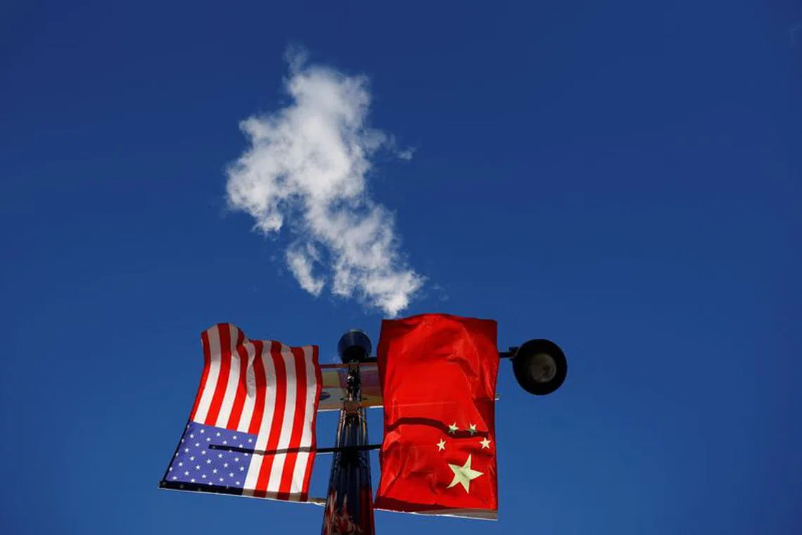 The flags of the United States and China fly from a lamppost in the Chinatown neighborhood of Boston, Massachusetts, U.S., November 1, 2021.   REUTERS/Brian Snyder/ File Photo