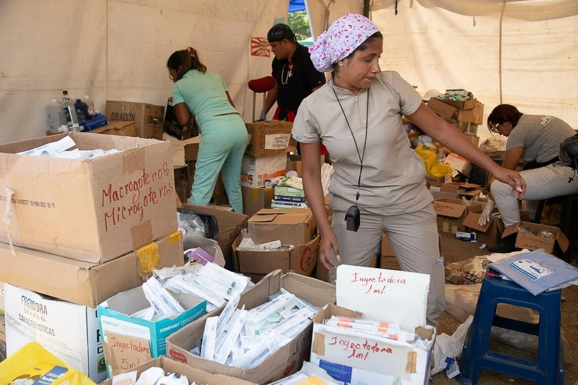 Volunteers organise supplies in a shelter following the June 24 earthquakes in Caraballeda, Venezuela, on July 1.