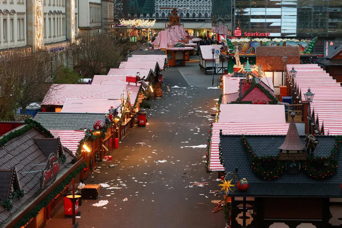 FILE PHOTO: Closed stalls stand at the site where a car drove into a crowd at a Magdeburg Christmas market in Magdeburg, Germany December 21, 2024. REUTERS/Christian Mang/File Photo