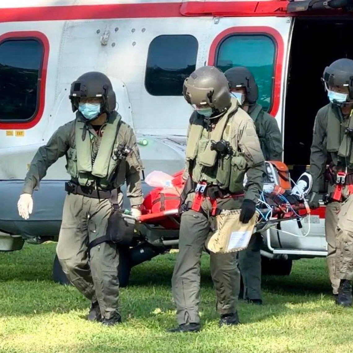 The rescue crew disembarking with the patient at Singapore General Hospital on Feb 7.