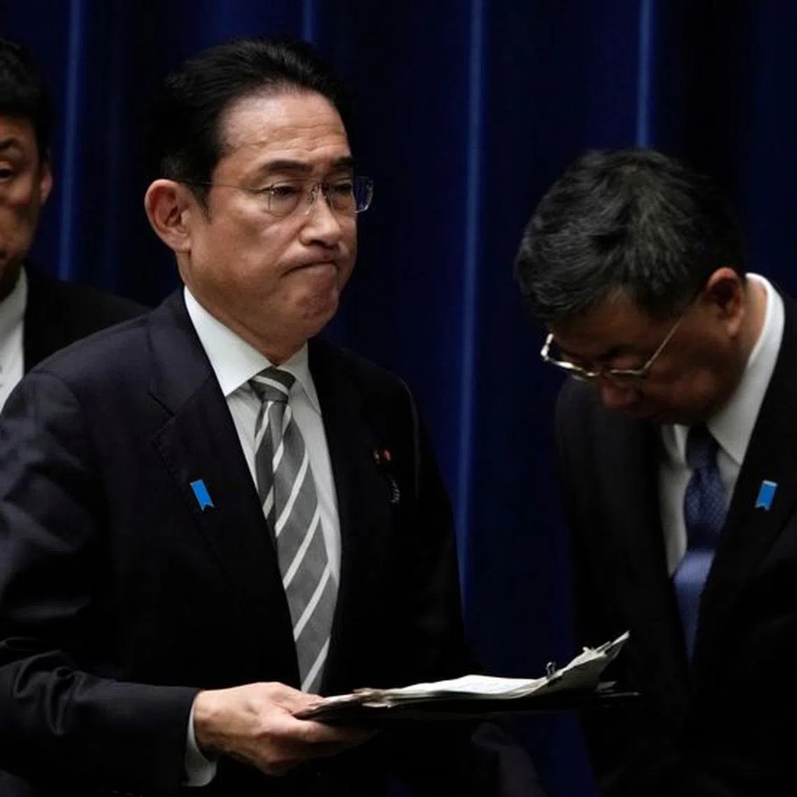 Japanese Prime Minister Fumio Kishida walks past Chief Cabinet Secretary Hirokazu Matsuno at the end of a news conference at the prime minister's office in Tokyo, Japan, 13 December 2023. Prime Minister Kishida said he will replace several ministers implicated in a political fundraising scandal.    FRANCK ROBICHON/Pool via REUTERS