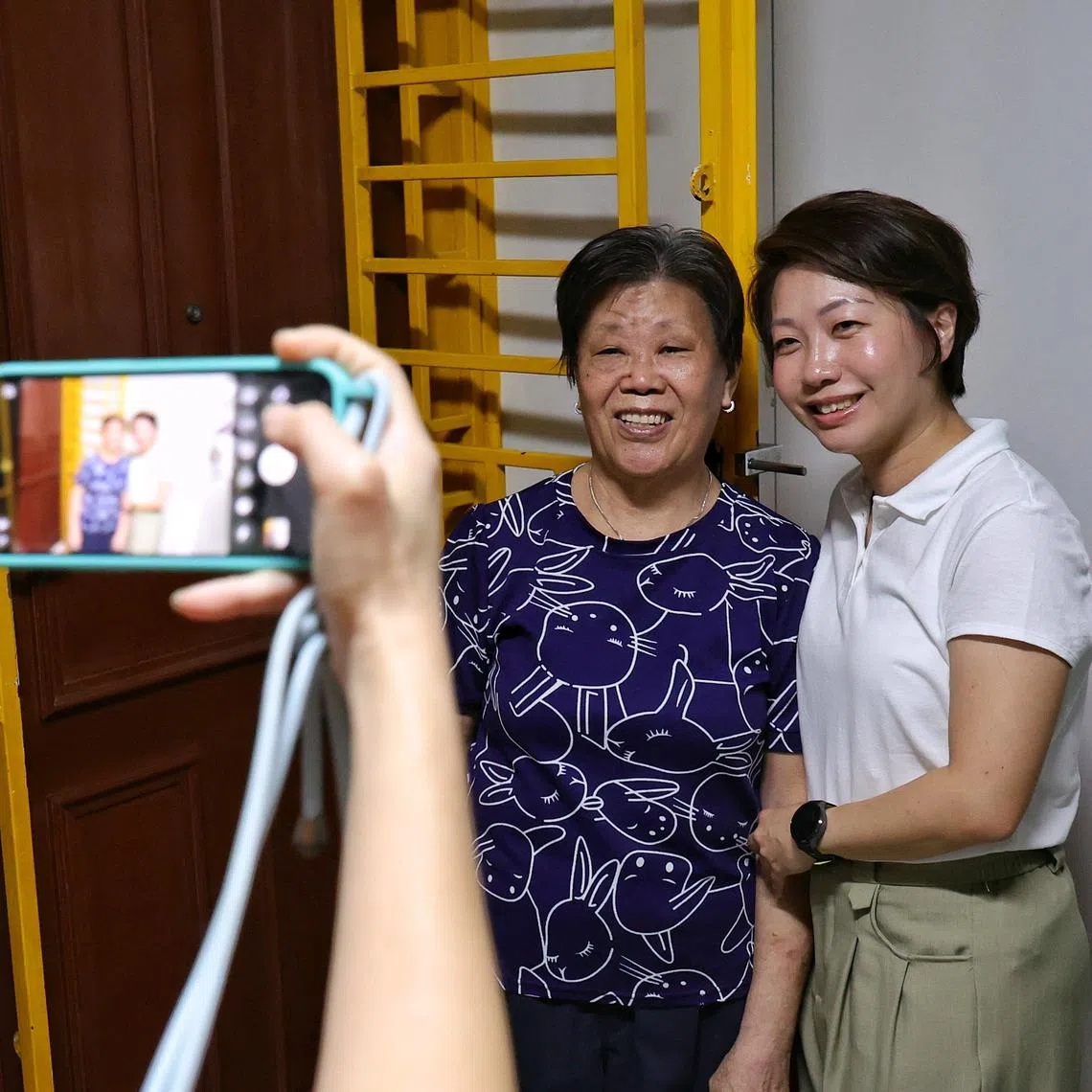 The PAP's Mountbatten SMC candidate Gho Sze Kee with a resident during house visits in Jalan Tiga on April 21.