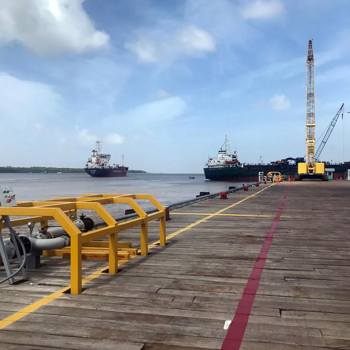 FILE PHOTO: Vessels carrying supplies for an offshore oil platform are seen, south of Georgetown, Guyana, January 23, 2020. REUTERS/Luc Cohen/File Photo